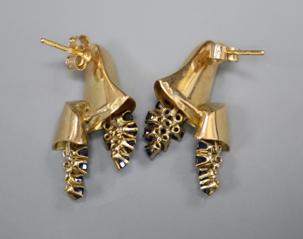 A pair of yellow metal (tests as 18ct) earrings of bell form set with sapphires, 24mm, gross 9.1 grams.
